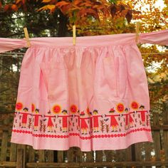 a pink skirt hanging from a clothes line