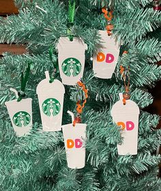 starbucks cup ornament hanging from a christmas tree