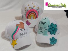 three hats with different designs on them and one has a rainbow, the other has a star