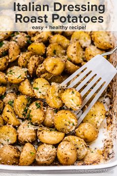 a close up of a fork in a casserole dish with potatoes and parsley