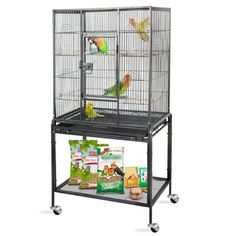 a large bird cage with two birds on it's top and one in the middle