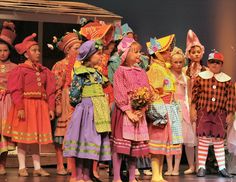 the children are dressed in colorful costumes