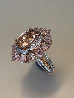 Stunning morganite ring with natural diamonds and pink sapphires, amazing example of jewelry craft. Anniversary present, or, maybe, engagement ring for very special woman. Ring specifications: Natural Morganite: oooooooooooooooooooo Weight: 5.4ct Color: pink salmon Shape: cushion Natural diamonds: oooooooooooooooooooo Weight: 0.68ct (68 pieces) Color:F Clarity: VS1 Pink Sapphires: oooooooooooooooo Weight: 6ct (12 pieces×0.5ct) Color: Light pink Shape: Pear Solid gold 18k Weight: 12.7gr Pearl Engagement Rings, Classy Accessories, Woman Ring, Pearl Engagement Ring, Rose Gold Morganite, Morganite Diamond, Pink Morganite, Morganite Ring