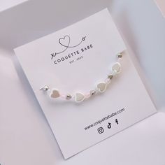 Handmade By Me One Size Stretchable Handmade Bracelet Packaging Ideas, White Heart Charm Bracelet For Everyday, White Dainty Bracelet With Heart Charm, Dainty Personalized White Heart Bracelet, Dainty White Personalized Heart Bracelet, White Heart Beads Jewelry For Mother's Day, Personalized White Heart Bracelet For Everyday Wear, Personalized White Heart Bracelet For Everyday, Everyday White Heart-shaped Beaded Bracelets