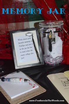 there is a glass jar with writing on it next to a notepad and pen