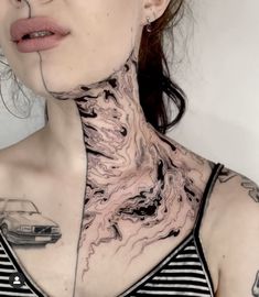 a woman with tattoos on her neck and chest