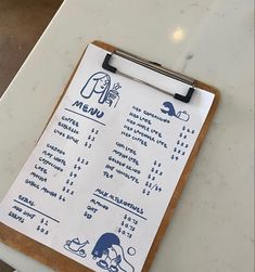 a menu on a clipboard sitting on top of a table