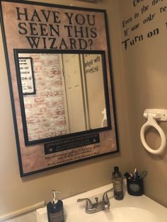 a bathroom sink with a mirror above it that says have you seen this wizard?