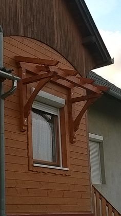 the corner of a house with a wooden roof