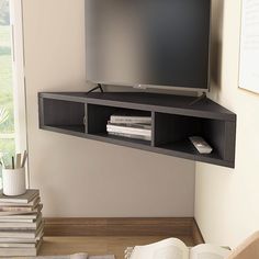 Make the most effective use of your wall space with this corner floating media console. Crafted from solid wood in a handsome cappuccino finish, this console fits efficiently into tight corners. This wall-mounted unit can accommodate up to a 46-inch flat screen TV and includes three open cubbies that add bonus storage and display space. Furniture of America Weinardt Modern/Contemporary Cappuccino Corner Tv Stand Integrated Tv Mount (Accommodates TVs up to 50-in) in Black | IDI-182358 Floating Corner Tv Stand Living Room, Corner Tv Shelf, Mounted Corner Tv, Mounted Tv Bedroom, Tv Bedroom Ideas, Corner Tv Ideas, Corner Tv Mount, Shelf Under Tv, Corner Tv Console