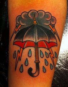 an umbrella with lightning and rain coming out of it is on the leg for someone to see