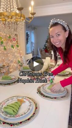 a woman in a red shirt is decorating plates with christmas tree decorations on them