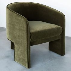 a green chair sitting on top of a gray floor