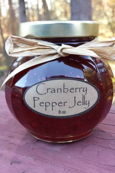 a jar of cranberry pepper jelly on a table