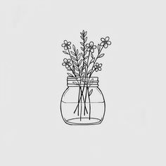 a jar filled with flowers sitting on top of a table