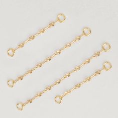 three pairs of gold filled chain bracelets on white background with space for text or image