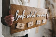 a person holding a wooden sign that says, i do what you want to do