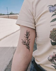 a person with a flower tattoo on their left arm and the other arm behind him