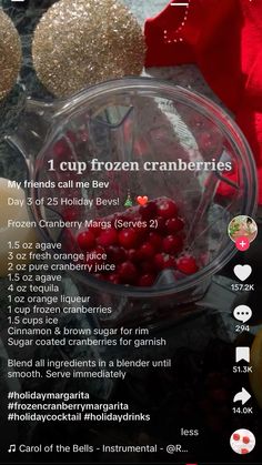 a glass bowl filled with cranberries on top of a table next to christmas decorations