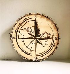 a wooden clock with an image of the world on it