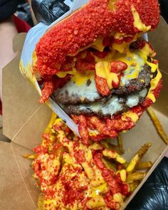 a large hamburger covered in cheese and ketchup