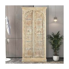 an old wooden cabinet next to a potted plant