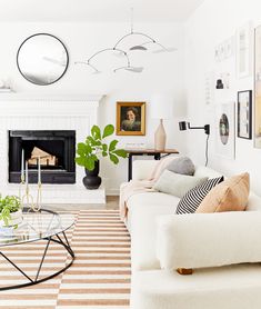 a living room filled with furniture and a fire place in the middle of the room