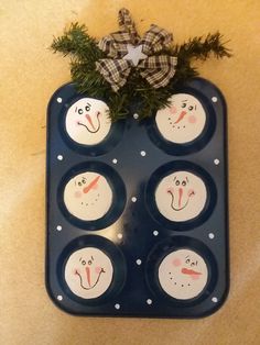 an egg tray with six snowmen painted on it