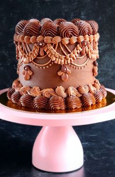 a chocolate cake sitting on top of a pink plate