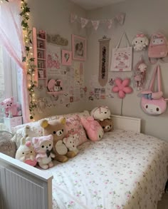 a child's bedroom decorated in pink and white with teddy bears on the bed