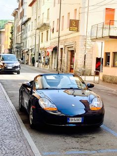 a black sports car parked on the side of a street