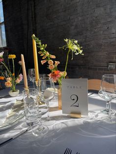 the table is set with flowers and candles