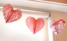 three paper hearts hanging from the ceiling