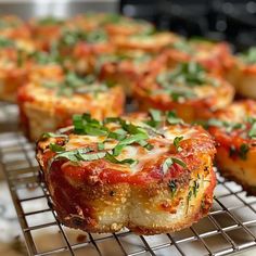 several small pizzas are cooling on a rack