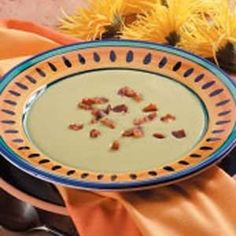 a blue and white plate sitting on top of a table next to some yellow flowers