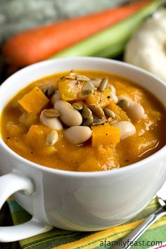 a white bowl filled with soup on top of a table