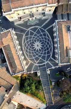 an aerial view of a large building with a circular design on the top and sides