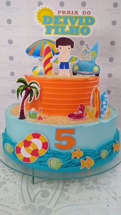 a birthday cake decorated with an image of a boy on the beach and lifeguards