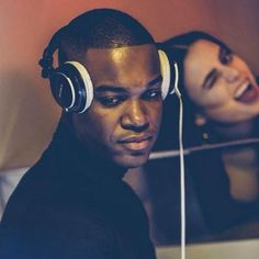 a young man wearing headphones and listening to music