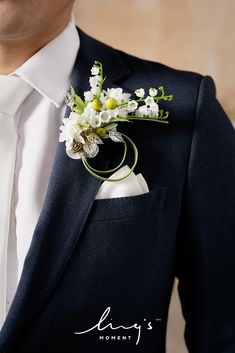 a man in a suit with a boutonniere on his lapel