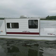 a white boat floating on top of a body of water