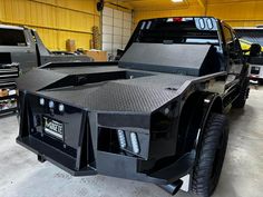 a large truck parked in a garage next to other trucks