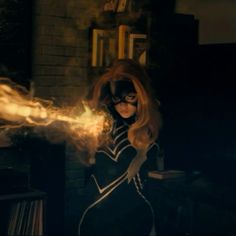 a woman dressed in black and white with fire coming out of her face