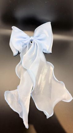 a white bow on top of a shiny surface