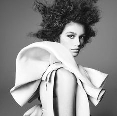 a black and white photo of a woman with curly hair