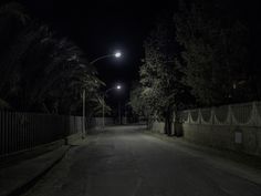 an empty street at night with the light on