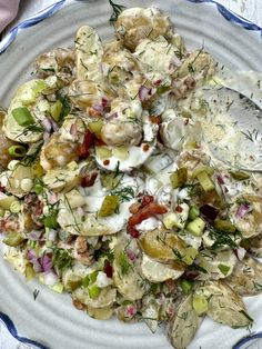 a white plate topped with potato salad and dressing