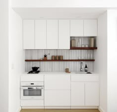 a kitchen with white cabinets and wooden shelves on the wall, along with a stove top oven