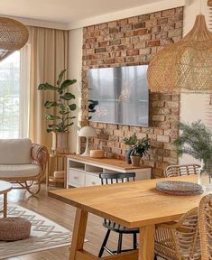 a living room filled with furniture and a flat screen tv mounted on the wall above a wooden table