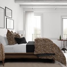 a leopard print bed spread in a white bedroom with black and brown accents on the walls